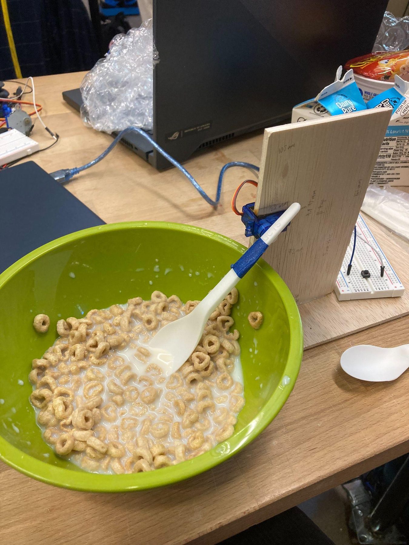 Alternate view of the cereal feeder prototype on the workbench