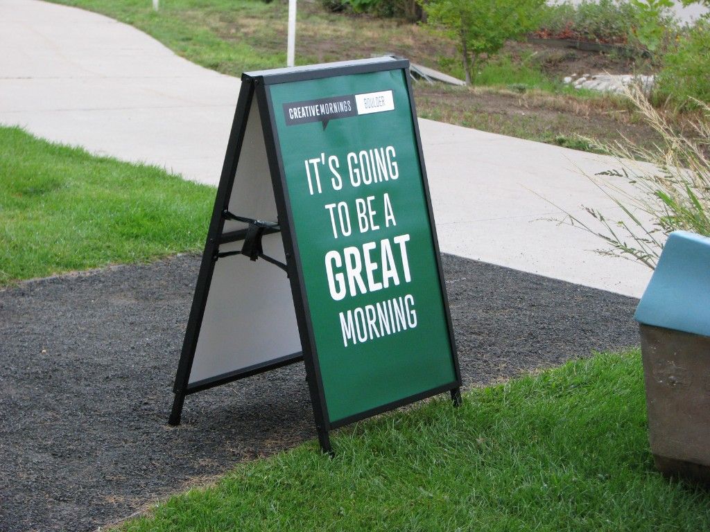 Green Creative Mornings Boulder sign reading It's going to be a great morning