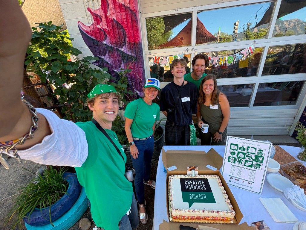 Selfie with the Creative Mornings Boulder team beside the one-year anniversary cake