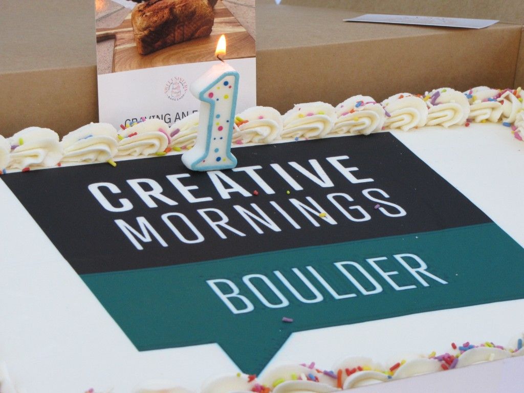 Creative Mornings Boulder cake with a lit number one candle