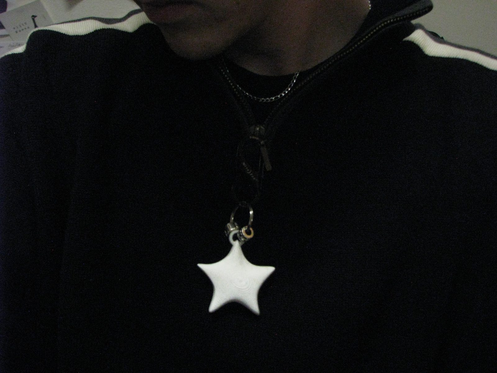 White star pendant hanging from a jacket zipper