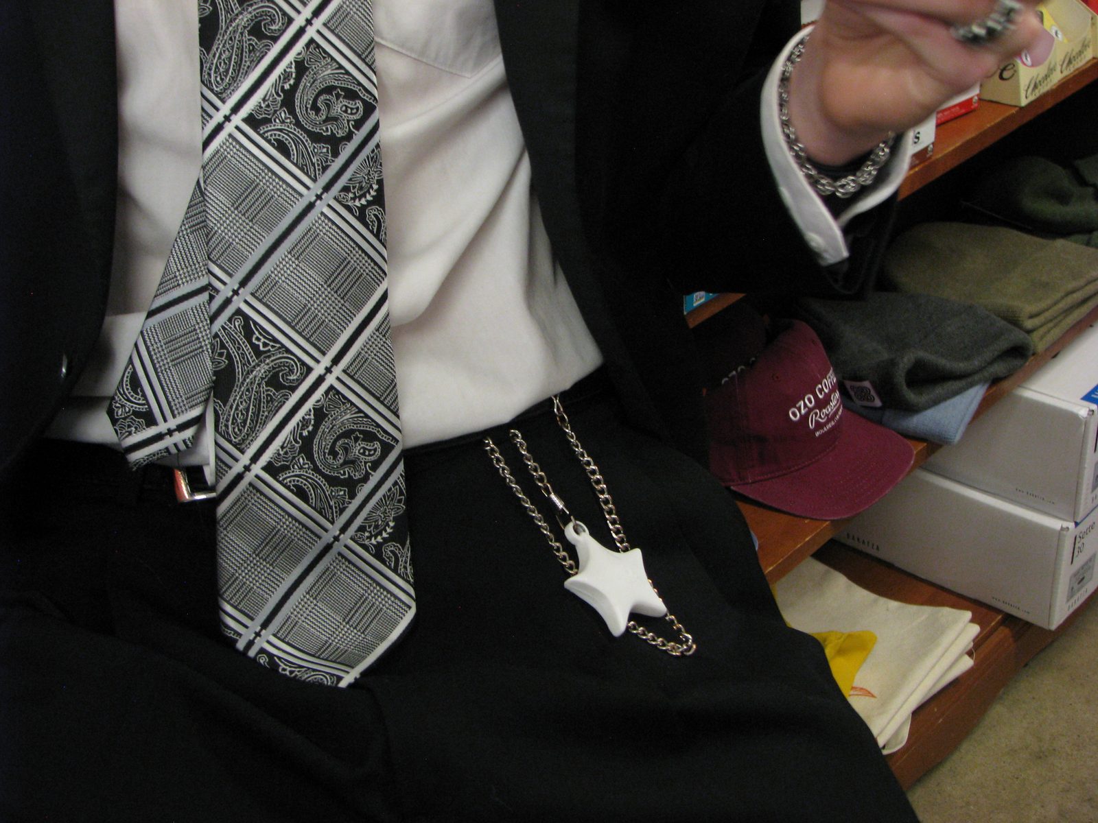 Star keychain hanging from a belt beside a shop shelf