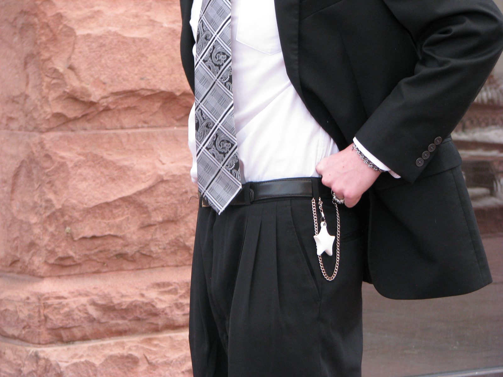 White 3D-printed star keychain hanging from a suit belt