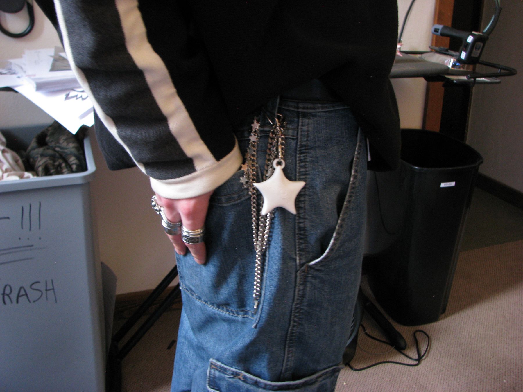 White star NODE charm clipped to jeans with a chain