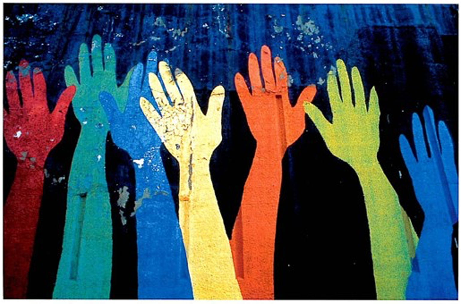 Painted hands raised against a blue wall