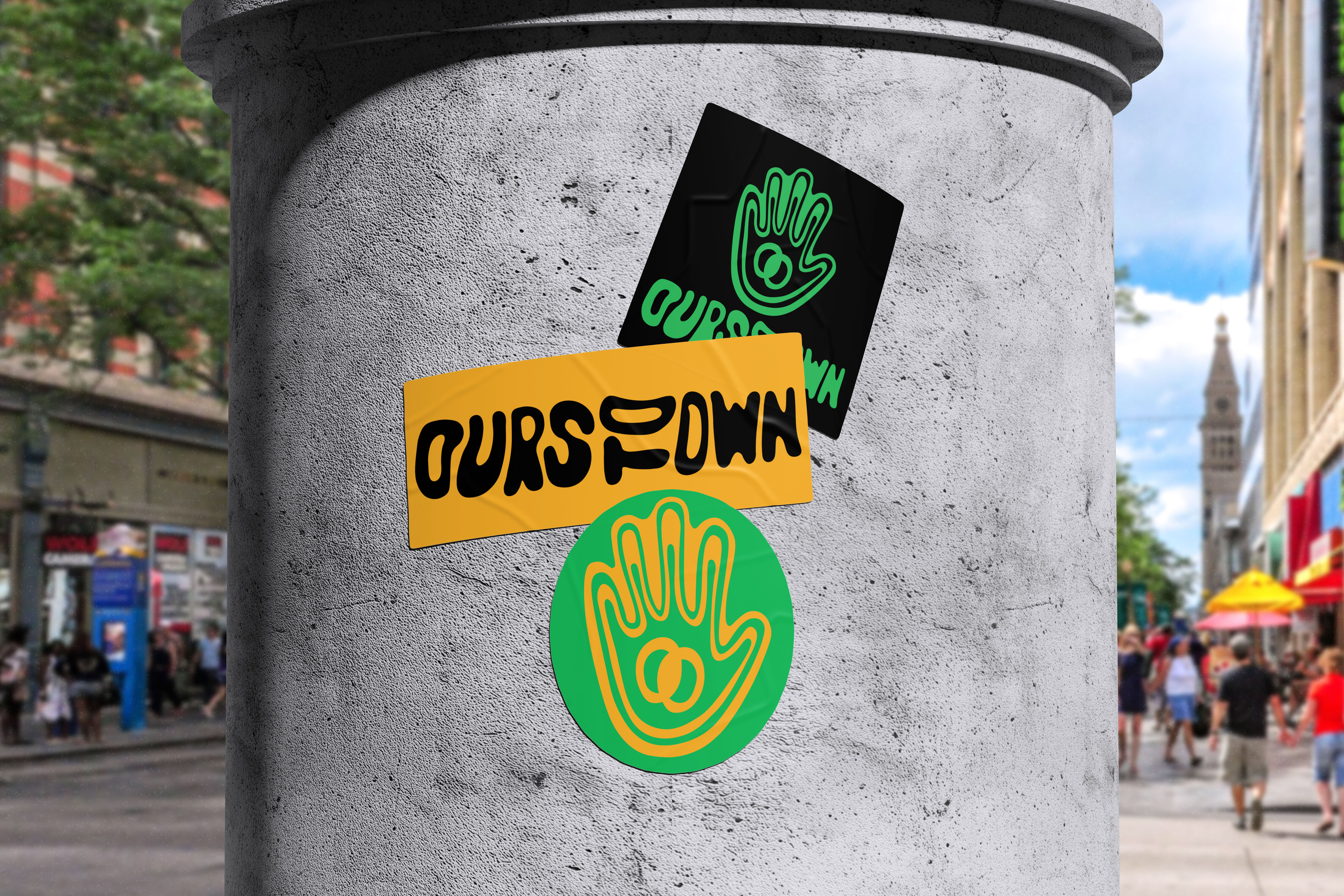 Ours To Own stickers on a concrete pillar on a Denver street