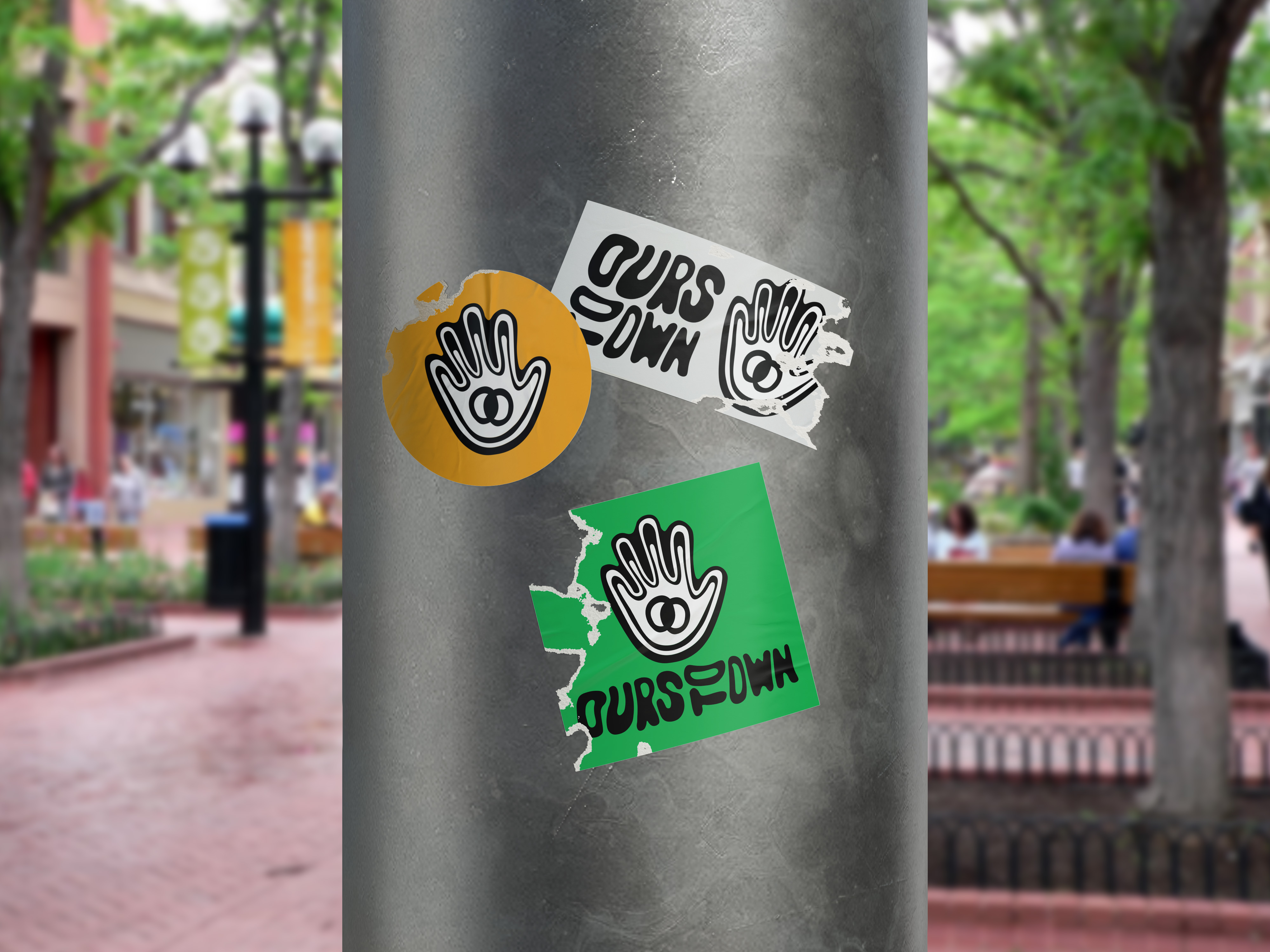Weathered Ours To Own stickers on a metal pole