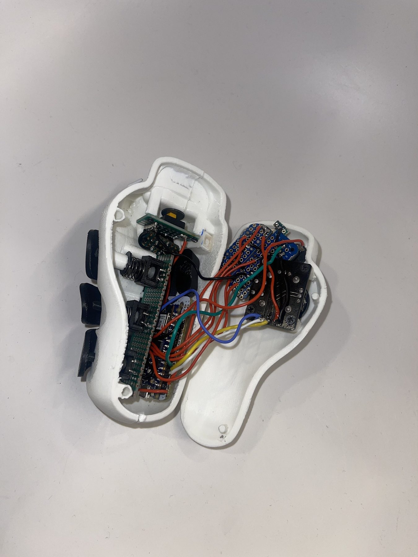 Opened SPUD controller showing internal wiring, boards, and button hardware